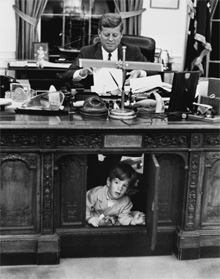 JFK with John Jr. under the Resolute Desk